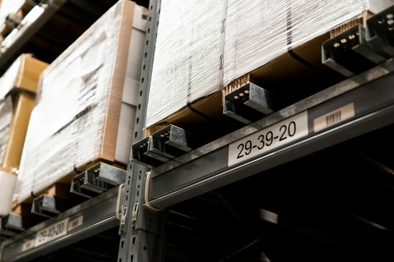 Packed materials on numbered industrial warehouse shelves