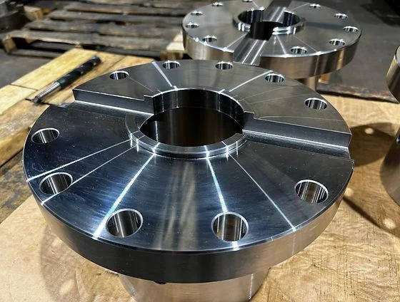 Machined steel flange with precision drilled bores