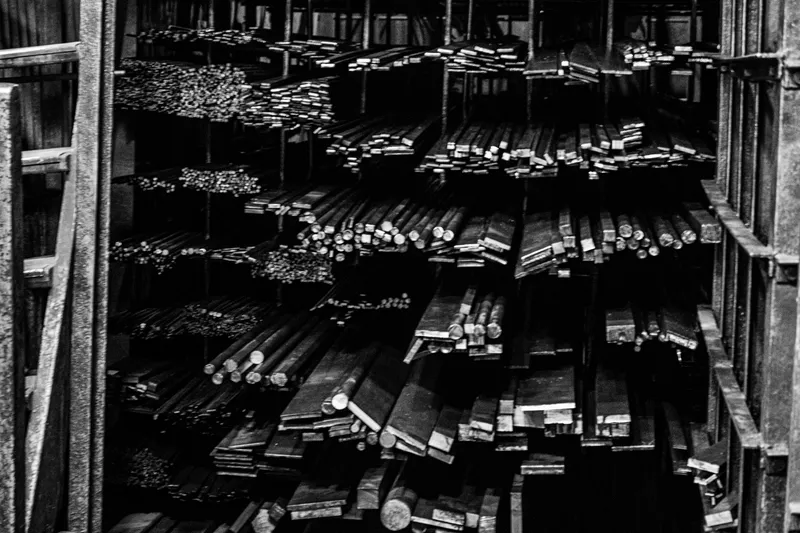 Shelves of metal bar stock in an industrial warehouse