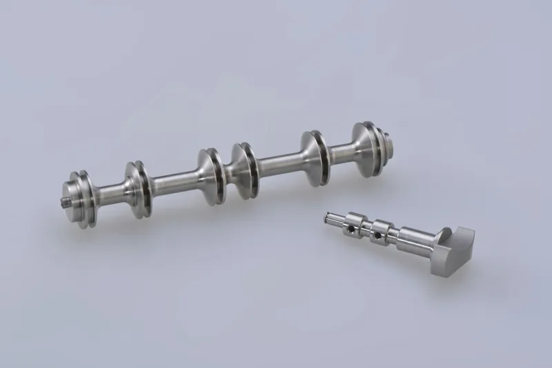 Precision turned steel shafts on a clean studio background