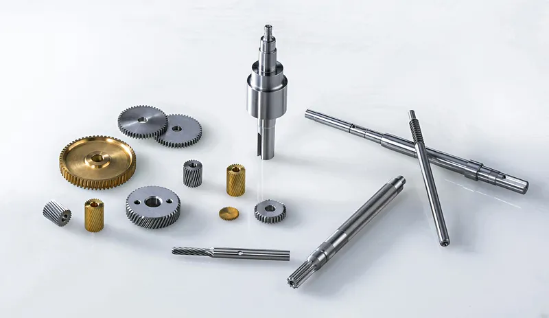 Assortment of turned steel shafts, brass wheels, bushes and small components